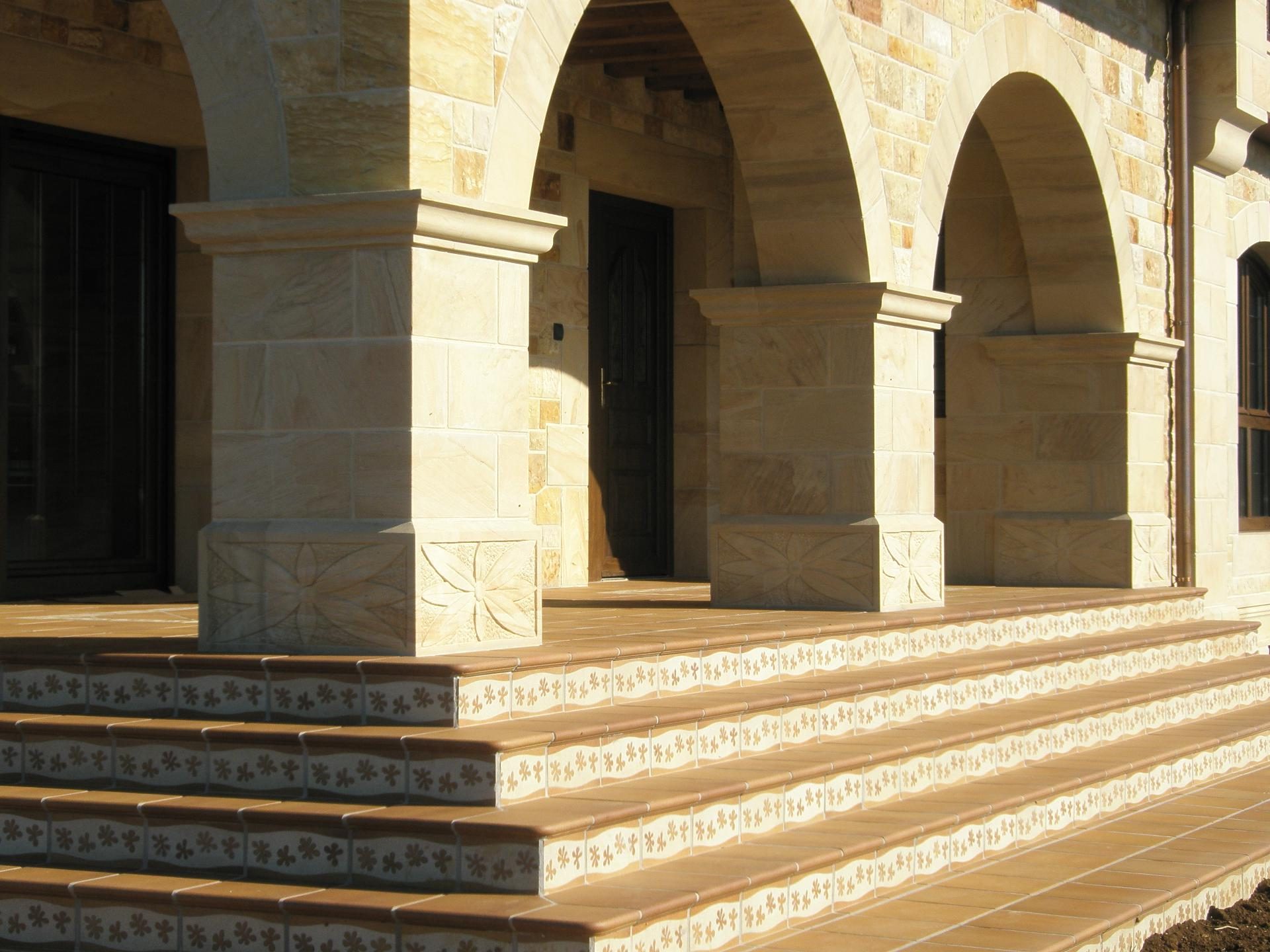 Porche de vivienda con columnas y escalinata de piedra